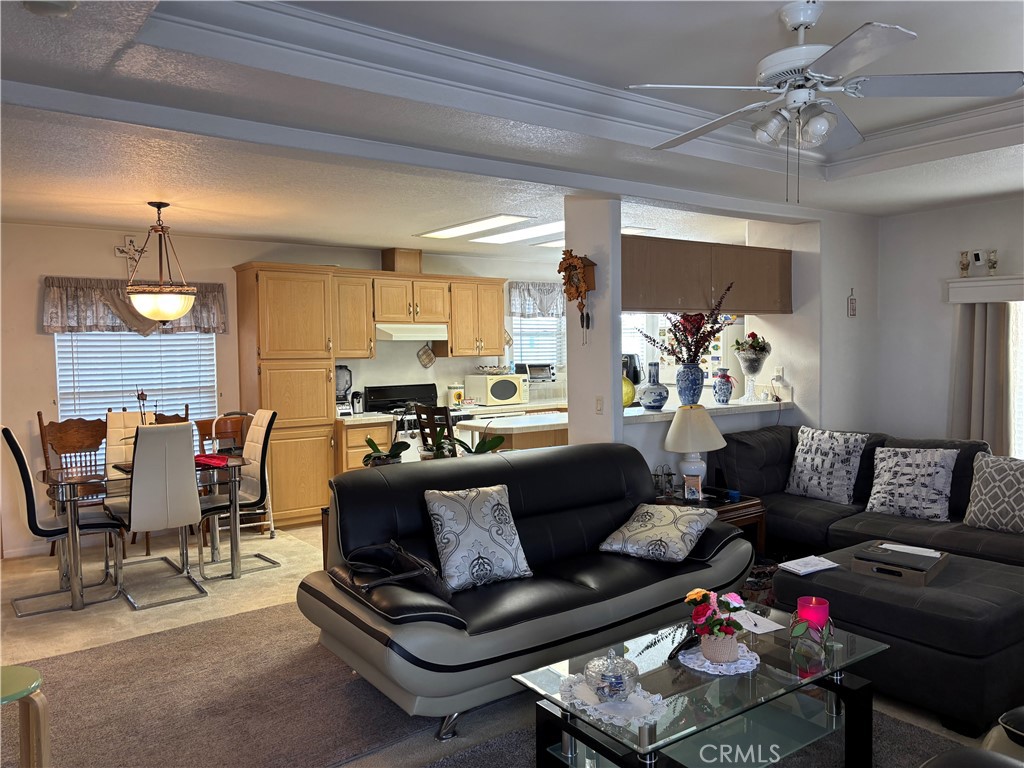 8389 Baker Avenue, Unit 82 Rancho Cucamonga, CA 91730 - Photo 2 of 13 a living room with furniture and a chandelier