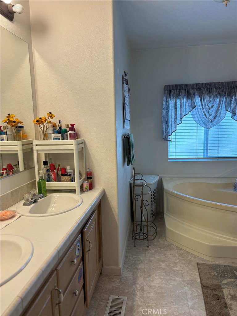 8389 Baker Avenue, Unit 82 Rancho Cucamonga, CA 91730 - Photo 8 of 13 a bathroom with a sink and a mirror