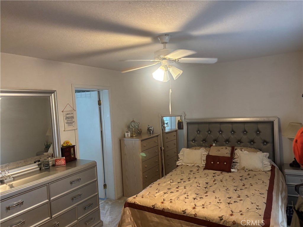 8389 Baker Avenue, Unit 82 Rancho Cucamonga, CA 91730 - Photo 10 of 13 a bedroom with a bed and teddy bear on bed