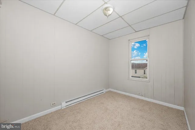 an empty room with a empty space and a ceiling fan