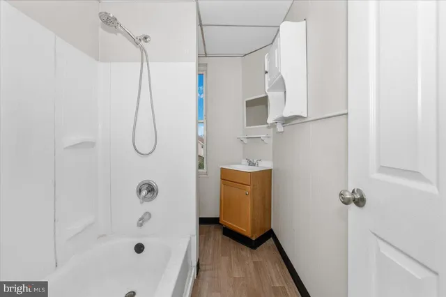 a bathroom with a bath tub a sink and a shower