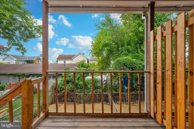 a view of a balcony with wooden floor and outdoor space