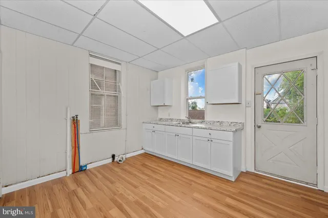 a kitchen with granite countertop white cabinets and white appliances
