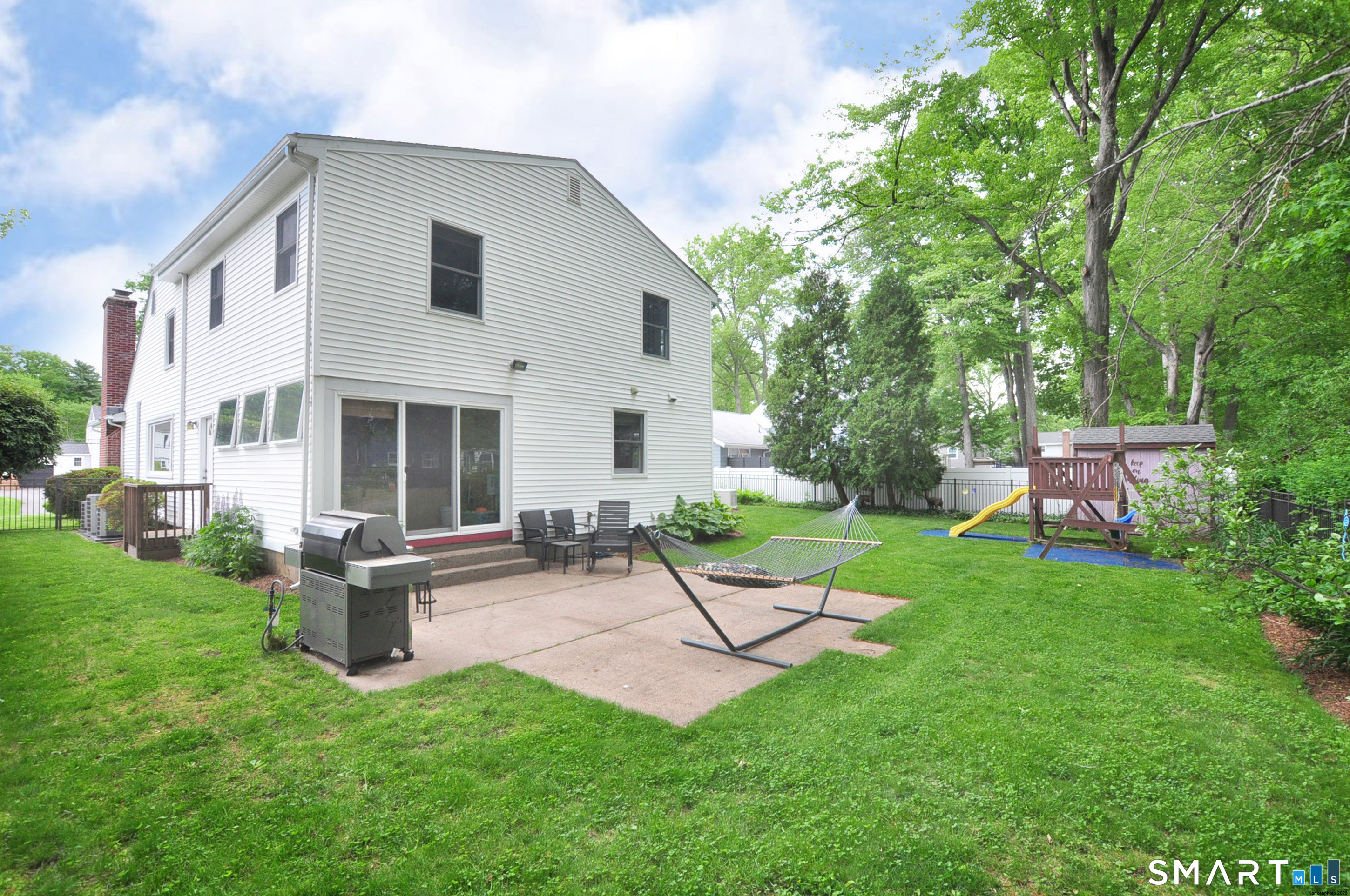 44 Miamis Road West Hartford, CT 06117 - Photo 36 of 39 a view of a house with backyard sitting area and garden