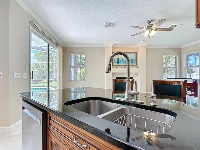 a view of an empty room with a window and cabinet