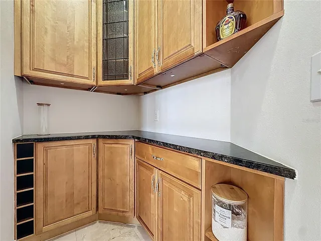 a view of an empty room with window and cabinet