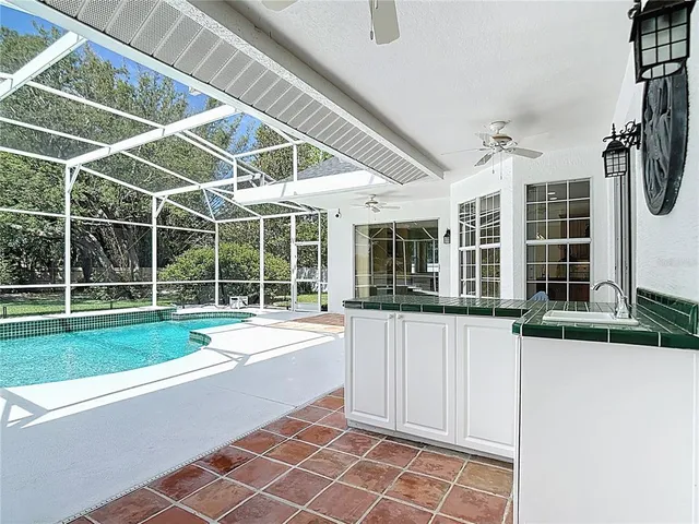 a view of a backyard with table and chairs potted plants
