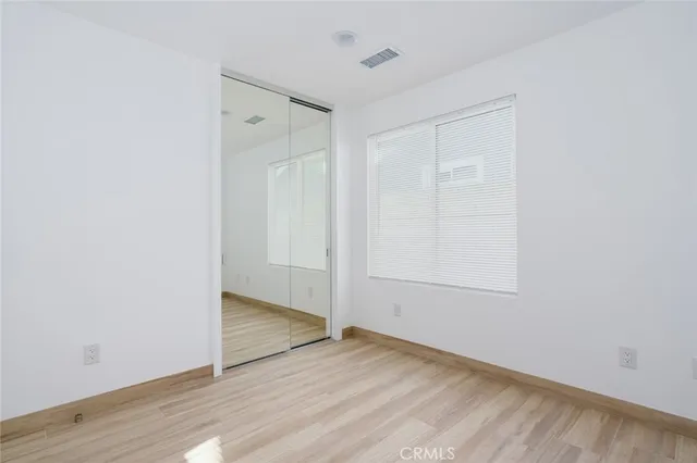 an empty room with wooden floor