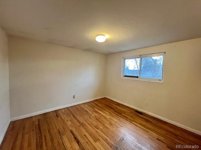 8950 Ithaca Way Westminster, CO 80031 - Photo 6 of 13 a view of empty room with wooden floor and fan
