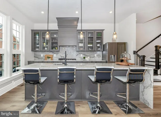 a kitchen with stainless steel appliances kitchen island a sink a counter space and a window