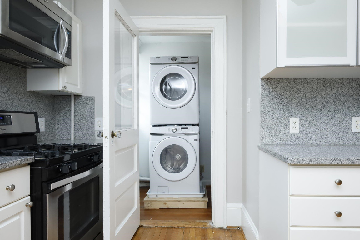 Undisclosed Address Raleigh, NC 27605 - Photo 11 of 38 a kitchen with a stove and a washer dryer