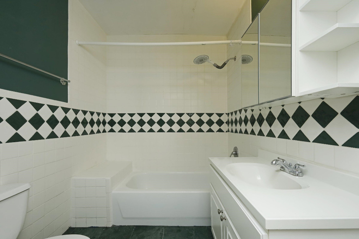 Undisclosed Address Raleigh, NC 27605 - Photo 13 of 38 a bathroom with a bathtub and a sink