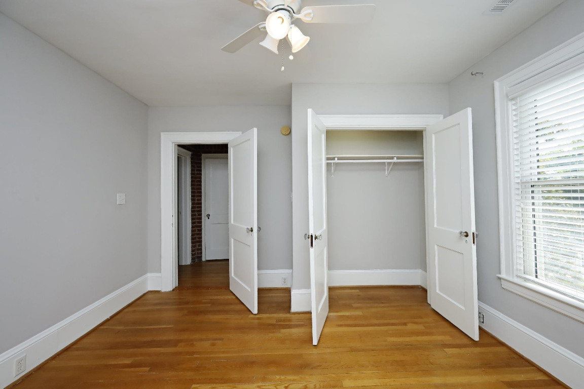 Undisclosed Address Raleigh, NC 27605 - Photo 15 of 38 a view of an empty room with wooden floor and a window