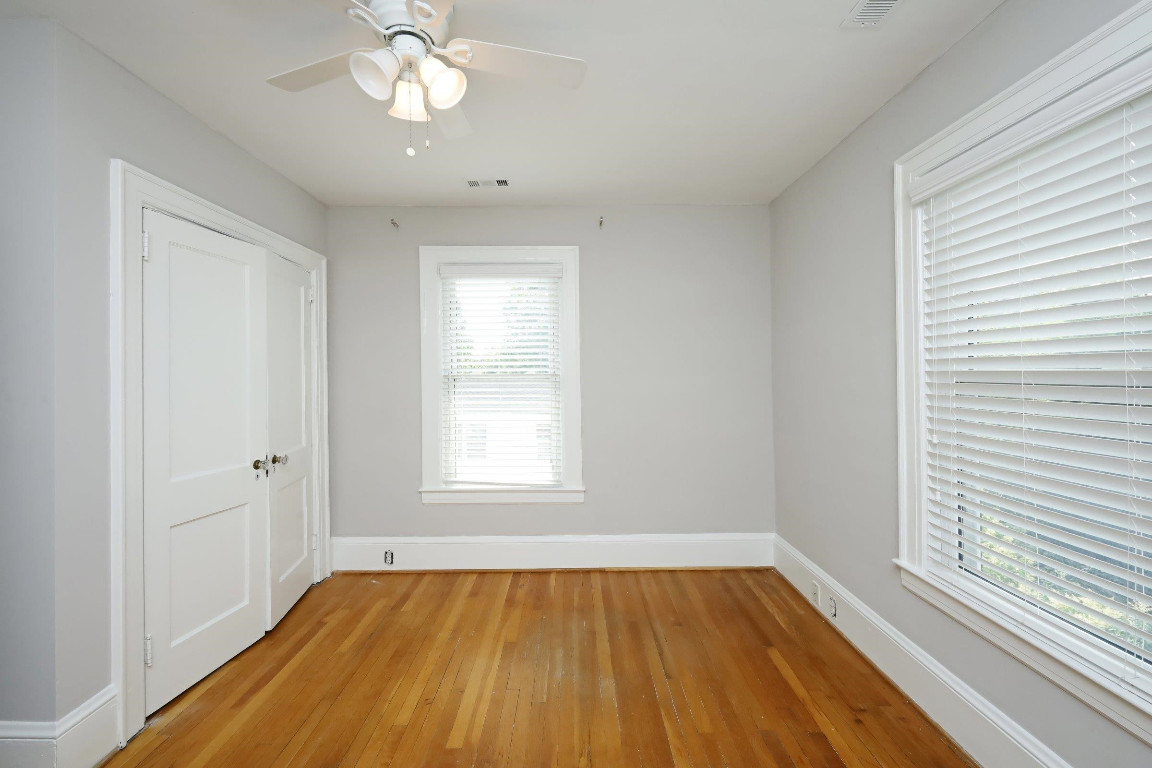Undisclosed Address Raleigh, NC 27605 - Photo 18 of 38 a view of an empty room with wooden floor and a window