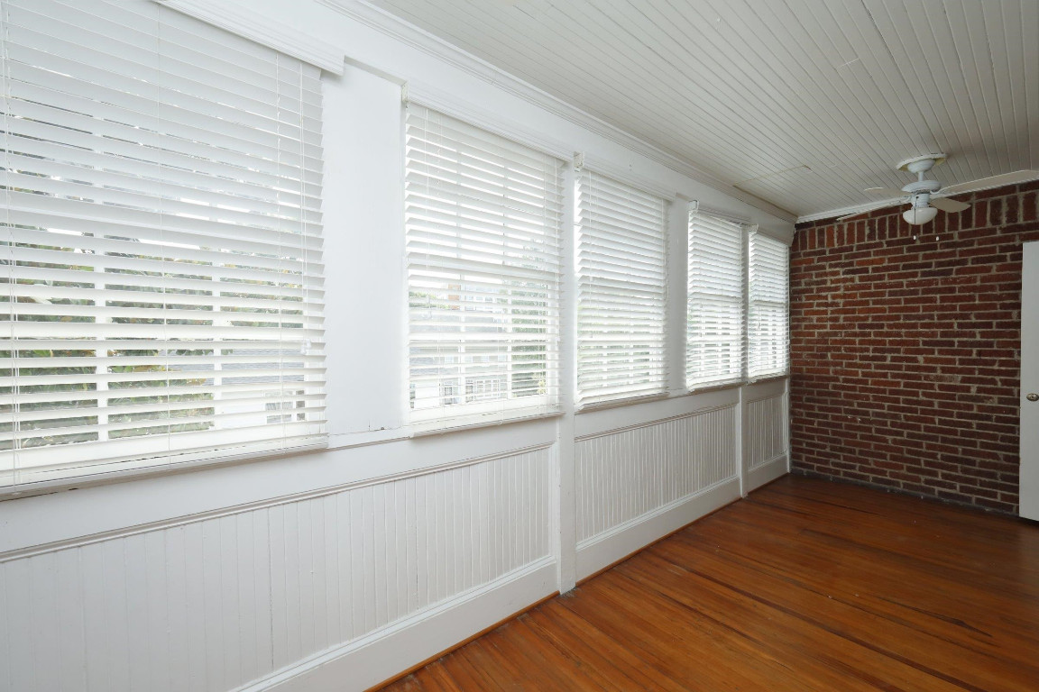 Undisclosed Address Raleigh, NC 27605 - Photo 20 of 38 a view of an empty room with wooden floor and a window