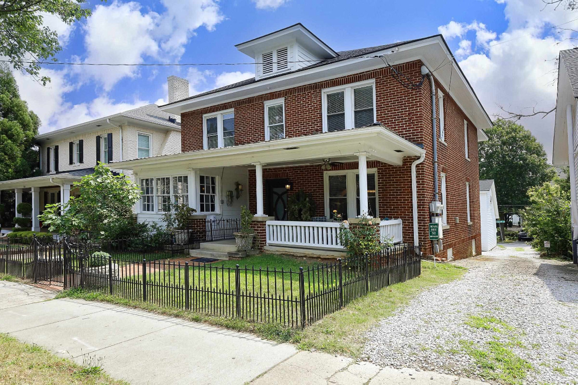 Undisclosed Address Raleigh, NC 27605 - Photo 2 of 38 a front view of house with a garden and plants