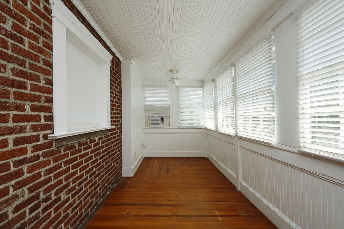 Undisclosed Address Raleigh, NC 27605 - Photo 22 of 38 a view of a hallway with wooden floor and staircase