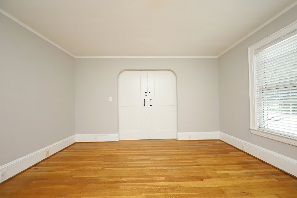 Undisclosed Address Raleigh, NC 27605 - Photo 23 of 38 a view of an empty room with wooden floor and a window