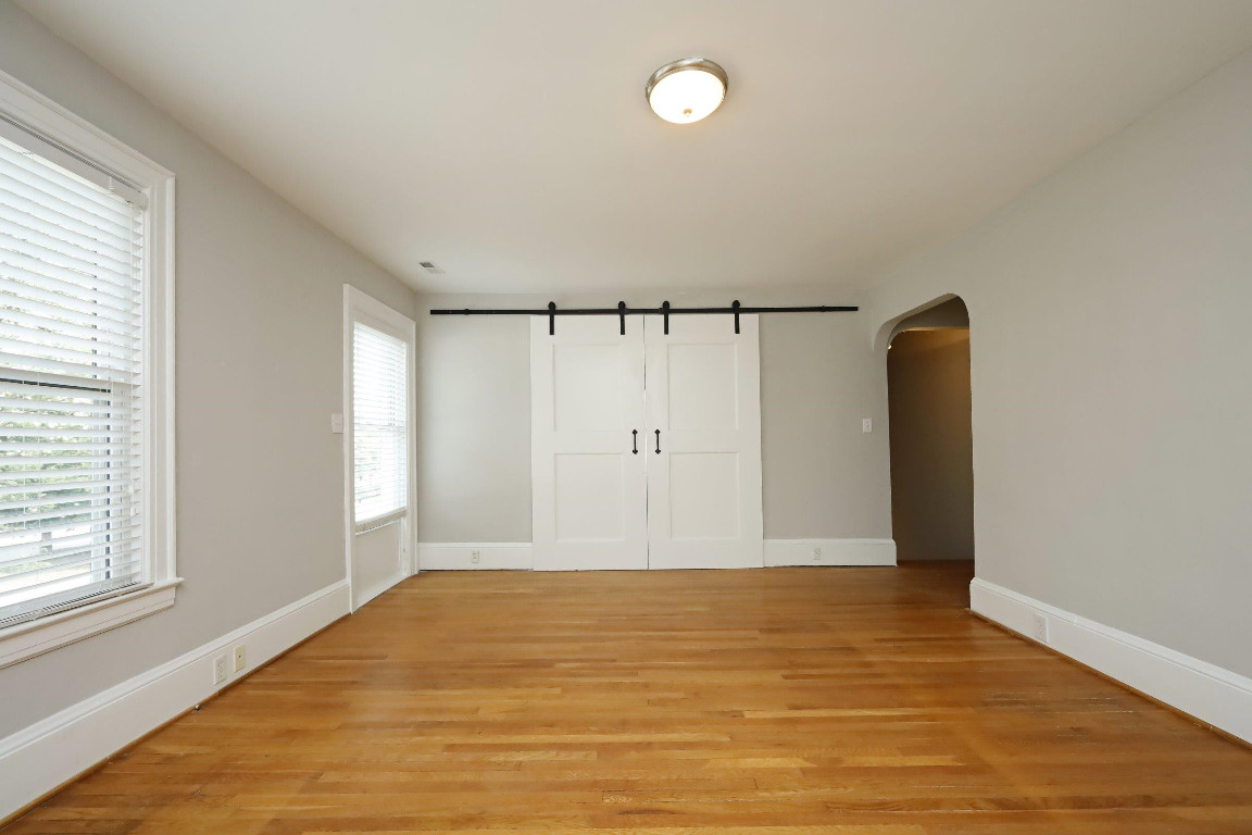 Undisclosed Address Raleigh, NC 27605 - Photo 25 of 38 a view of a room with wooden floor and window