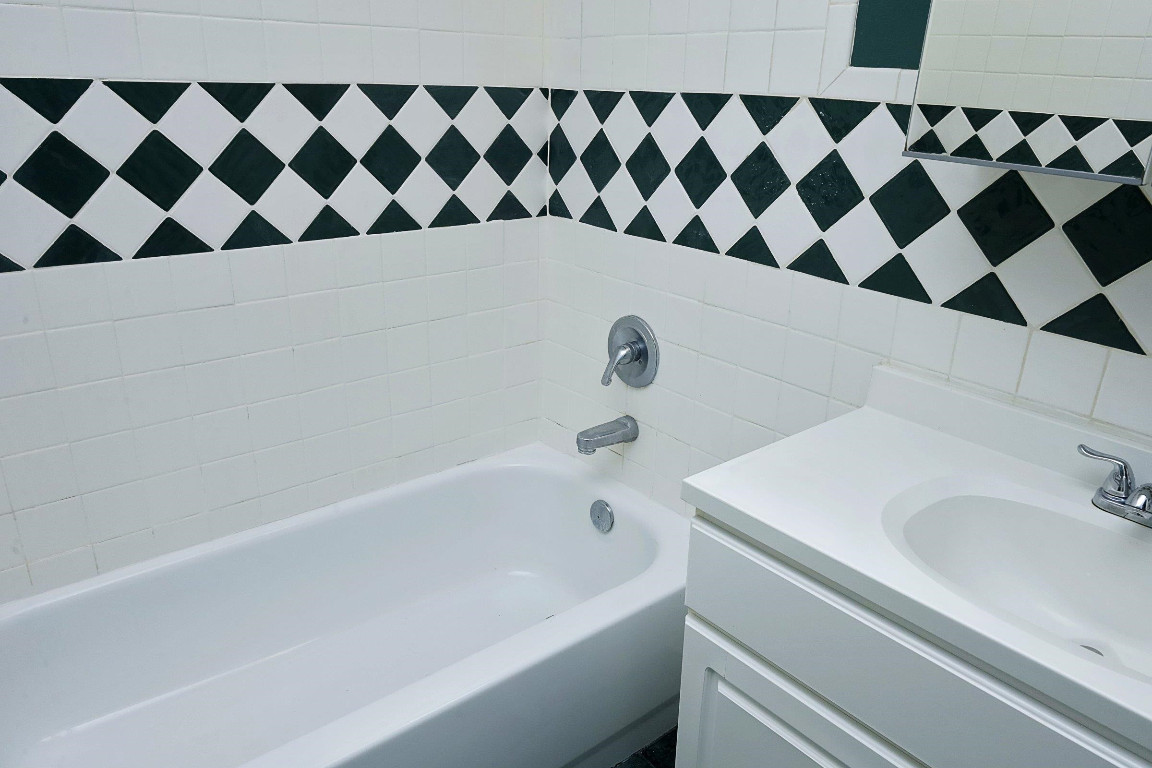 Undisclosed Address Raleigh, NC 27605 - Photo 28 of 38 a bathroom with a bathtub and a sink