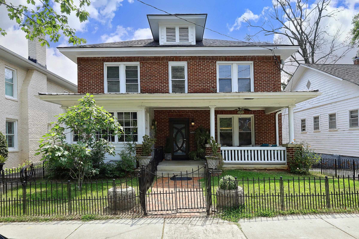 Undisclosed Address Raleigh, NC 27605 - Photo 29 of 38 a front view of a house with a garden