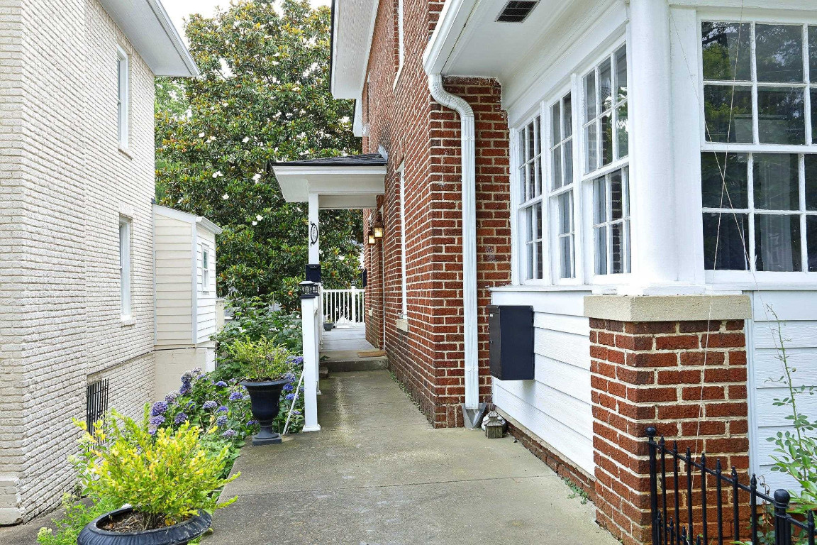Undisclosed Address Raleigh, NC 27605 - Photo 36 of 38 a front view of a house with a garden