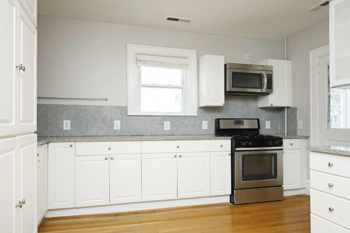 Undisclosed Address Raleigh, NC 27605 - Photo 5 of 38 a kitchen with stainless steel appliances granite countertop a sink and a stove