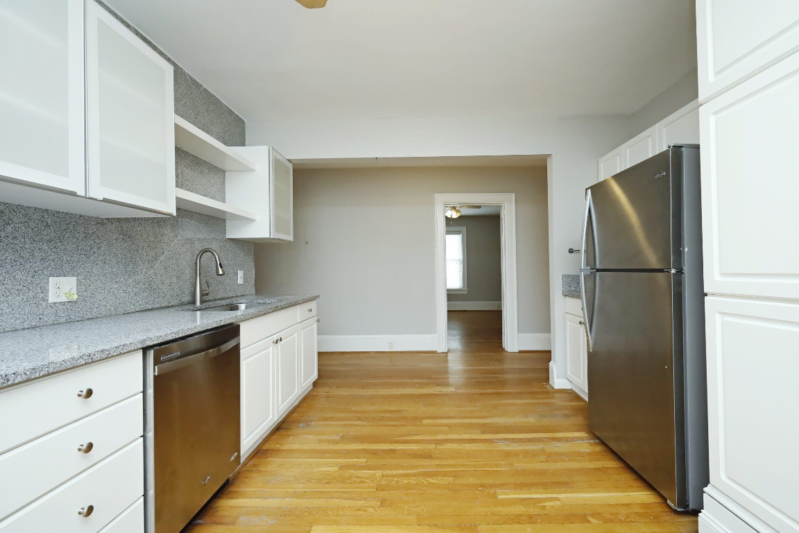 Undisclosed Address Raleigh, NC 27605 - Photo 7 of 38 a large kitchen with cabinets and wooden floor