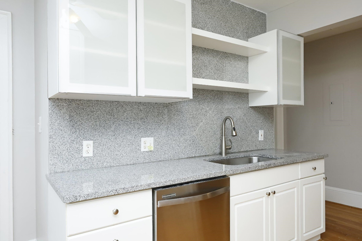 Undisclosed Address Raleigh, NC 27605 - Photo 8 of 38 a kitchen with granite countertop white cabinets and a sink