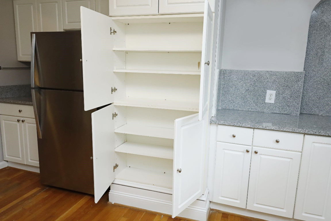 Undisclosed Address Raleigh, NC 27605 - Photo 9 of 38 a view of walk in closet with empty racks