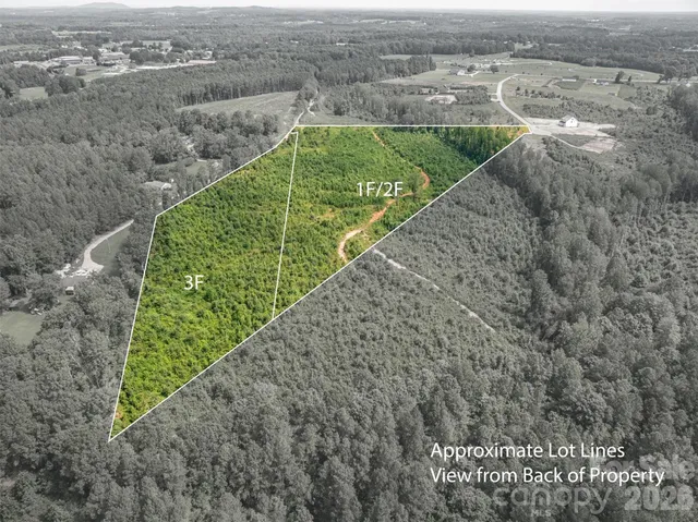 a view of a yard with wooden fence