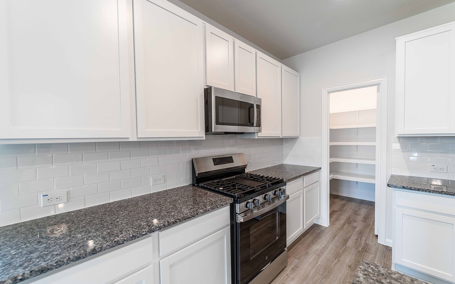 4326 Maple Root Lane Pinehurst, TX 77362 - Photo 10 of 19 a kitchen with granite countertop a sink and a stove top oven