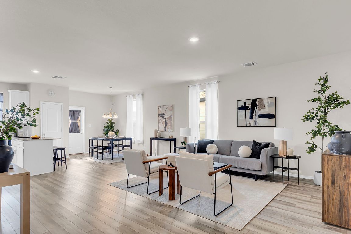 a living room with furniture and a potted plant