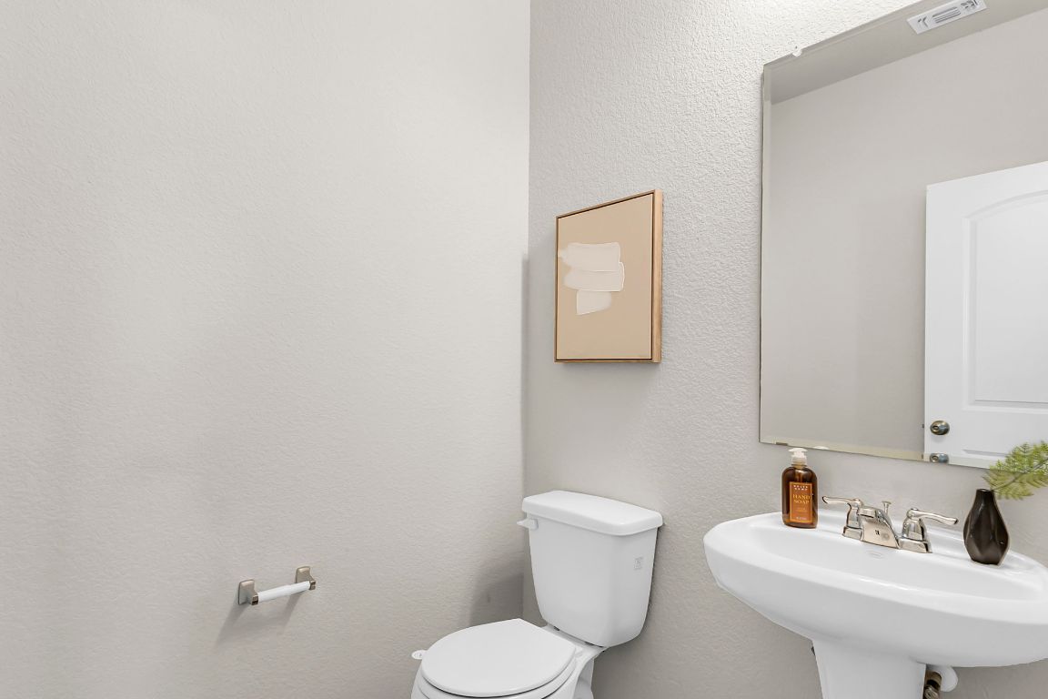 112 Black Alder Street Georgetown, TX 78626 - Photo 12 of 37 a bathroom with a toilet sink and mirror