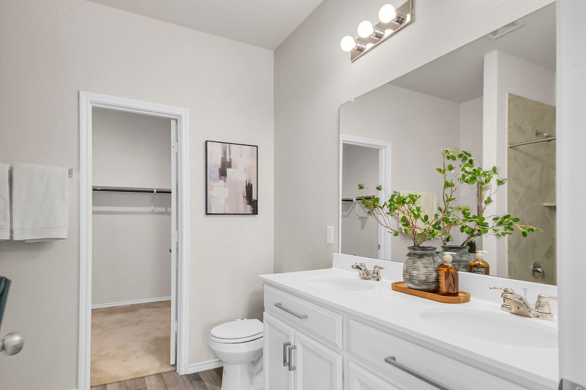 112 Black Alder Street Georgetown, TX 78626 - Photo 15 of 37 a bathroom with a sink a toilet and a mirror