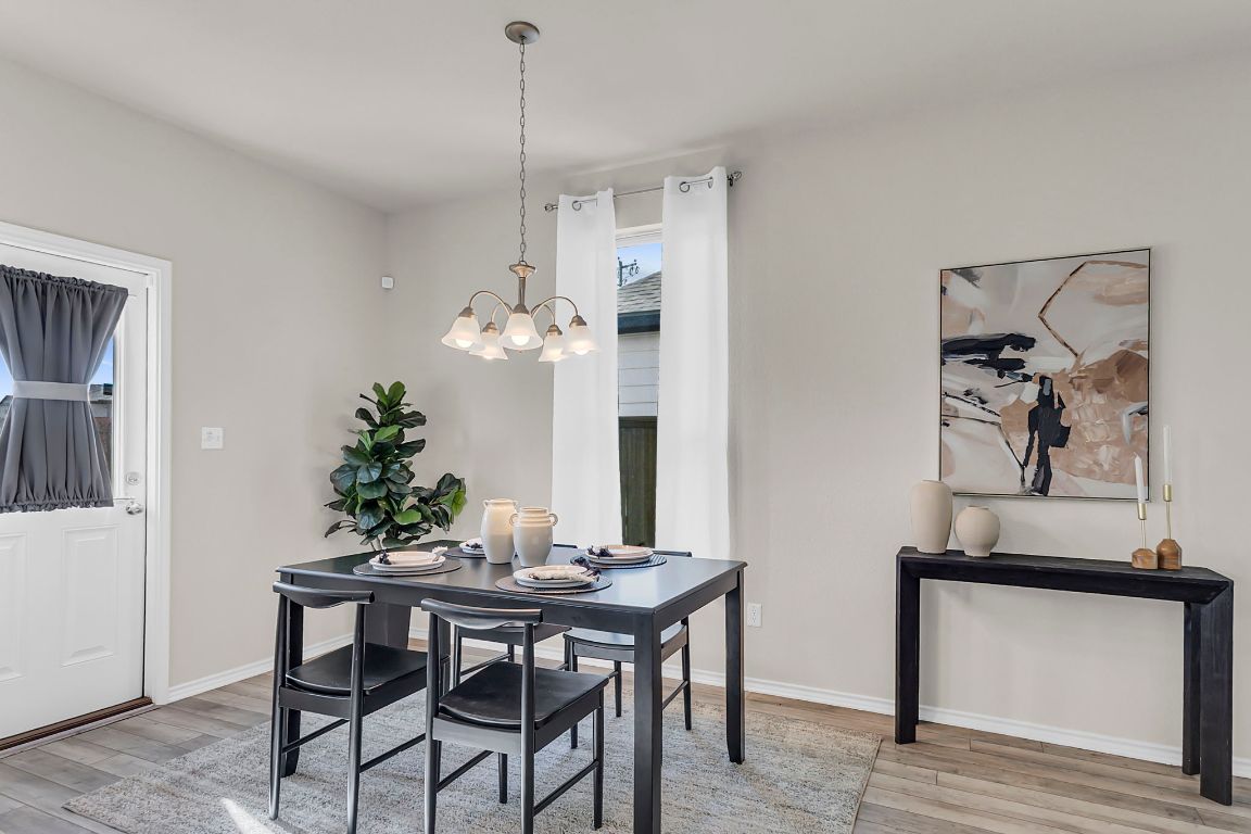 112 Black Alder Street Georgetown, TX 78626 - Photo 8 of 37 a view of a dining room with furniture and wooden floor