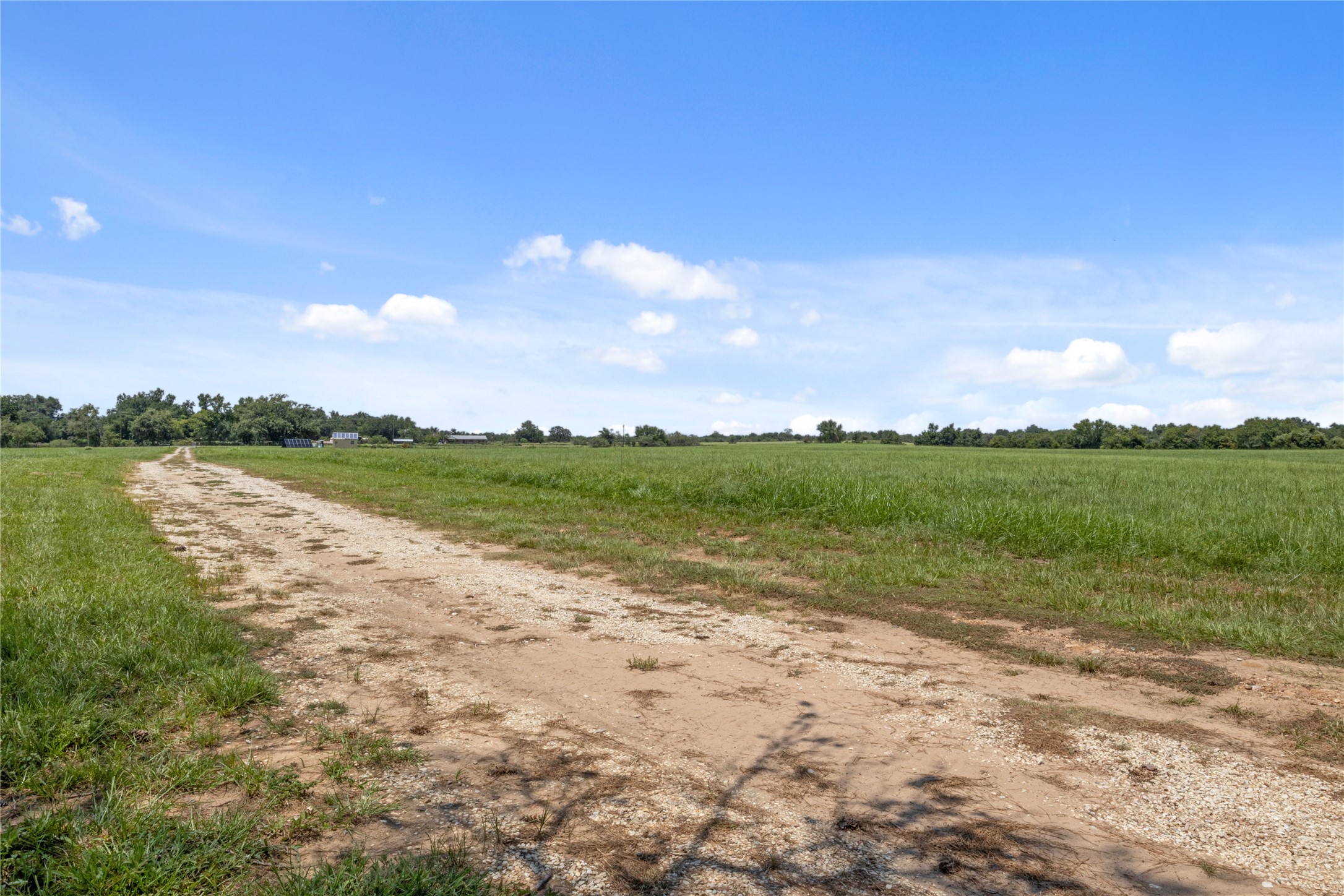 451 Pleasant Grove Road Elgin, TX 78621 - Photo 18 of 32 a view of a lake with houses in the back