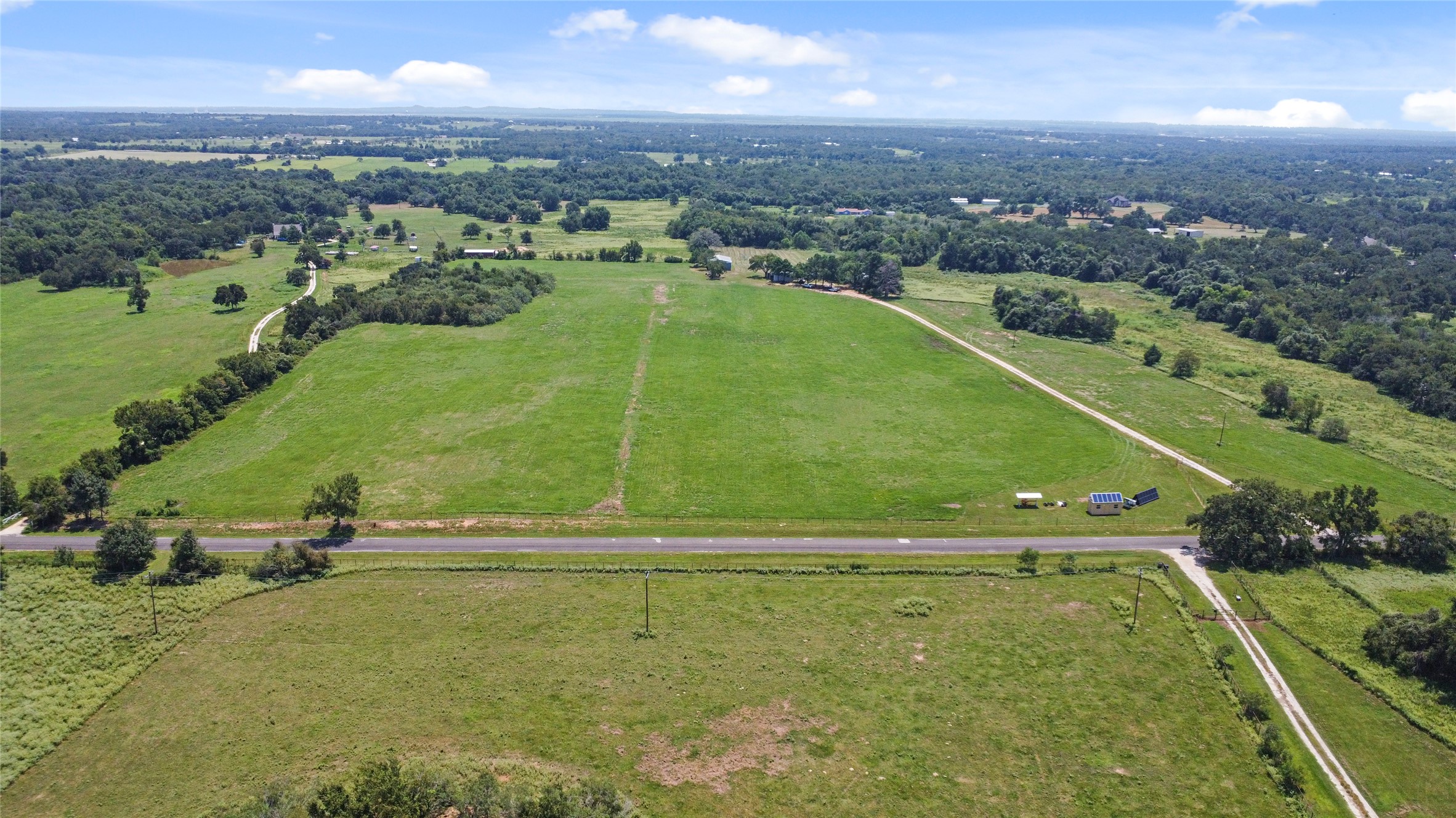 451 Pleasant Grove Road Elgin, TX 78621 - Photo 28 of 32 an aerial view of residential houses with outdoor space and river