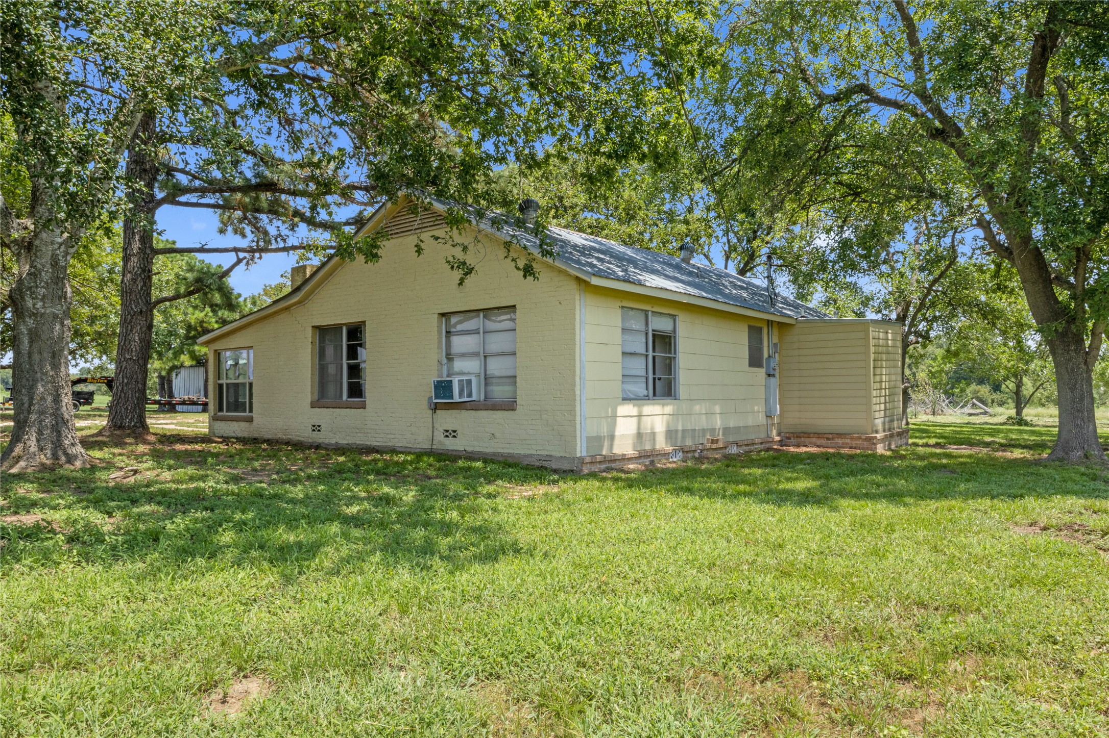 451 Pleasant Grove Road Elgin, TX 78621 - Photo 4 of 32 a house view with a garden space