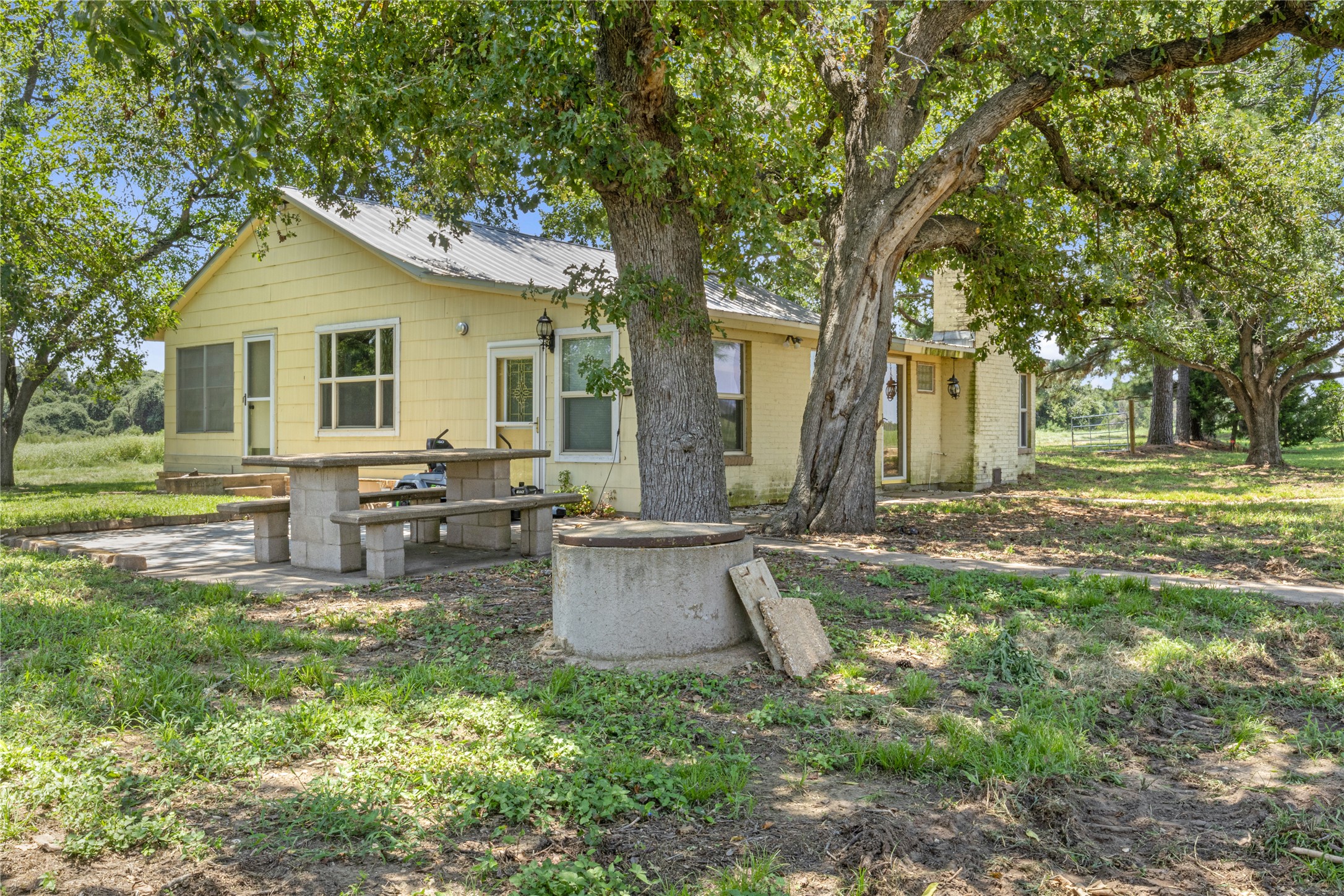 451 Pleasant Grove Road Elgin, TX 78621 - Photo 5 of 32 a view of a house with backyard and sitting area