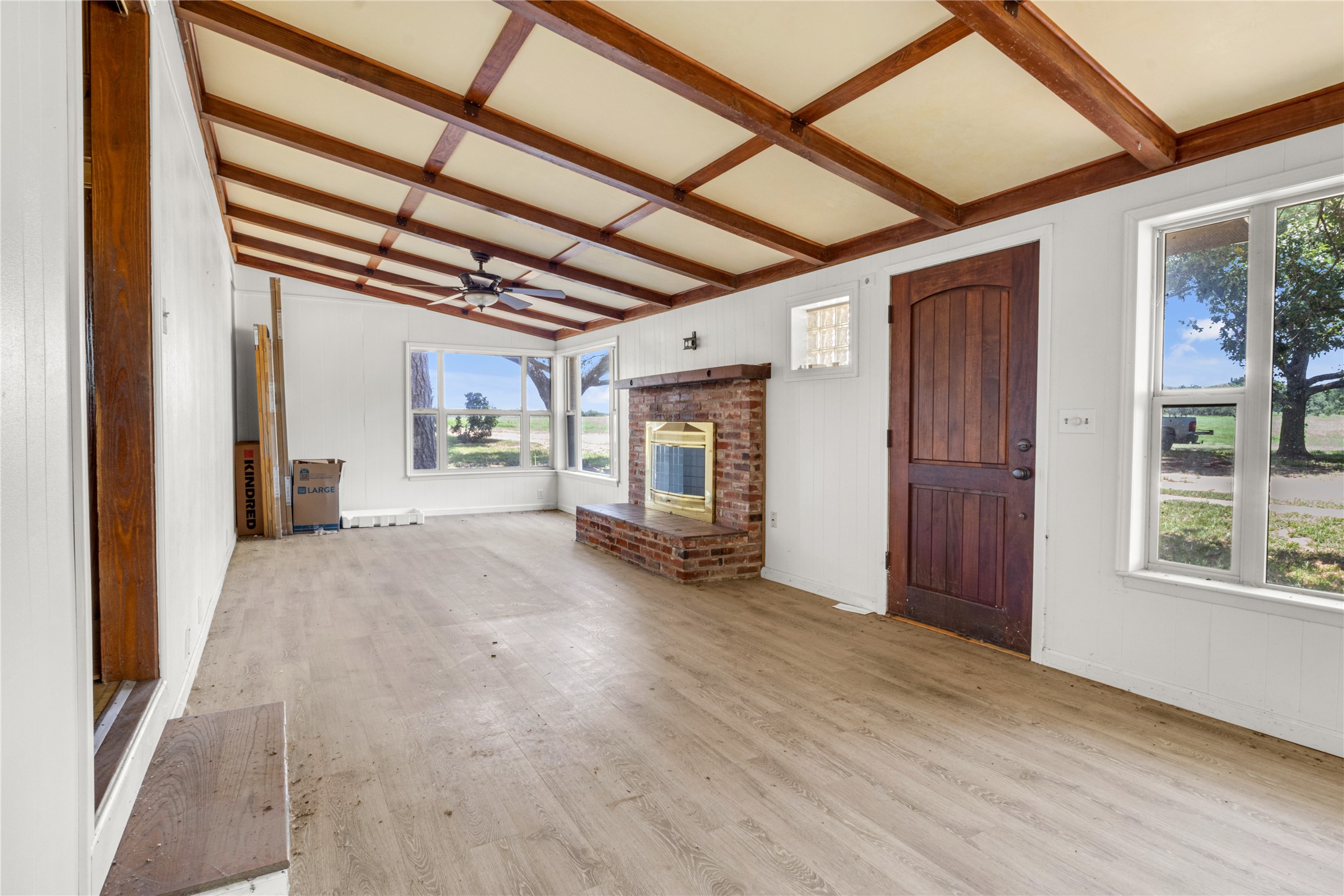 451 Pleasant Grove Road Elgin, TX 78621 - Photo 6 of 32 a view of an empty room with wooden floor and a window