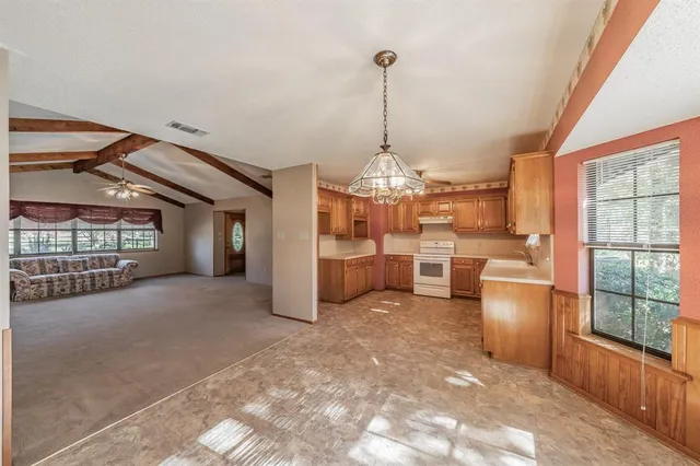 a kitchen with stainless steel appliances granite countertop a sink and cabinets