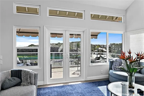 a living room with furniture and a floor to ceiling window
