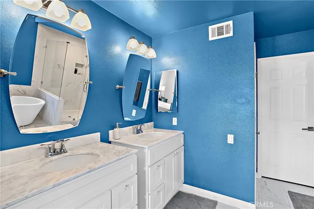 a bathroom with a double vanity sink and a mirror