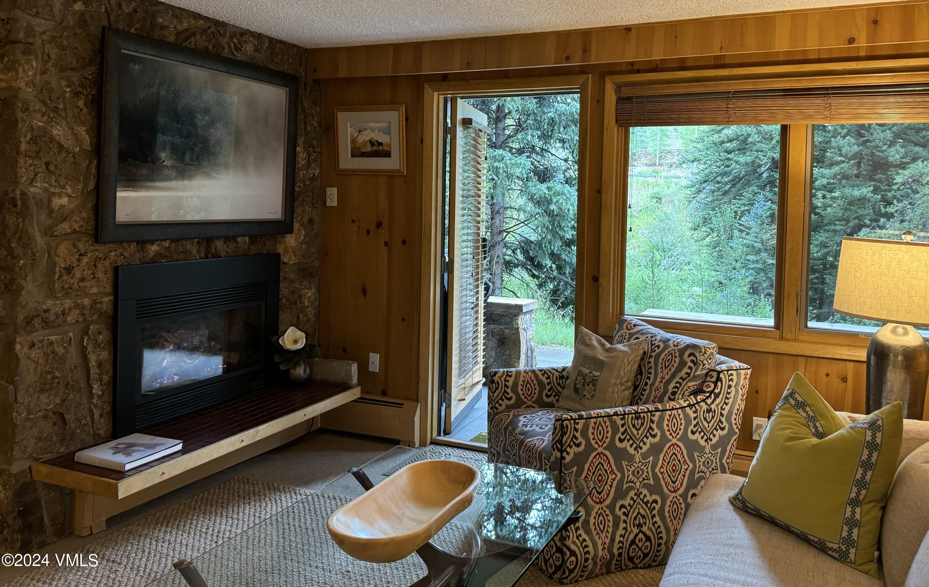 595 Vail Valley Drive, Unit E121 Vail, CO 81657 - Photo 2 of 12 a living room with furniture and a fireplace