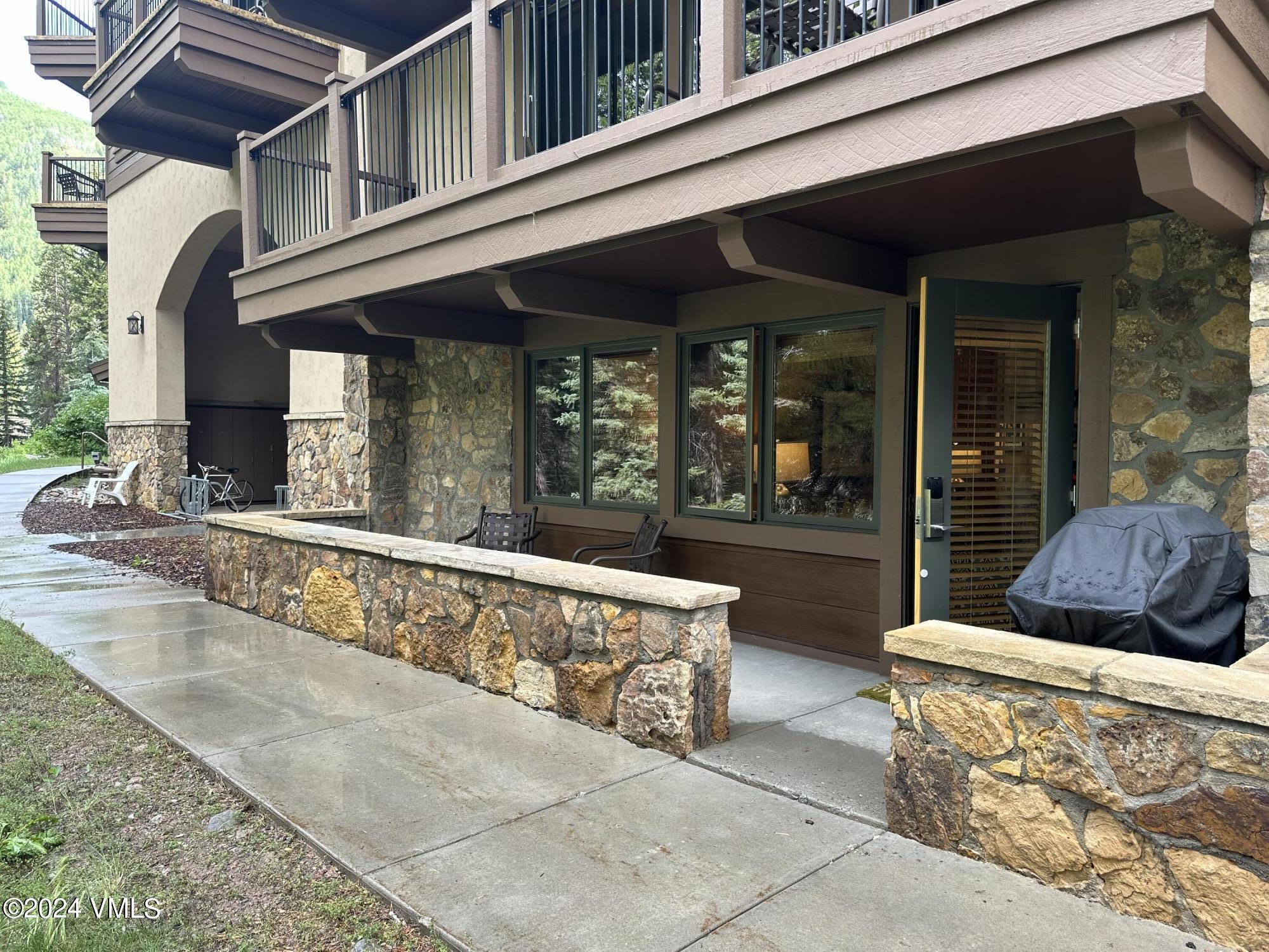 595 Vail Valley Drive, Unit E121 Vail, CO 81657 - Photo 3 of 12 front view of a building with a large window and potted plants