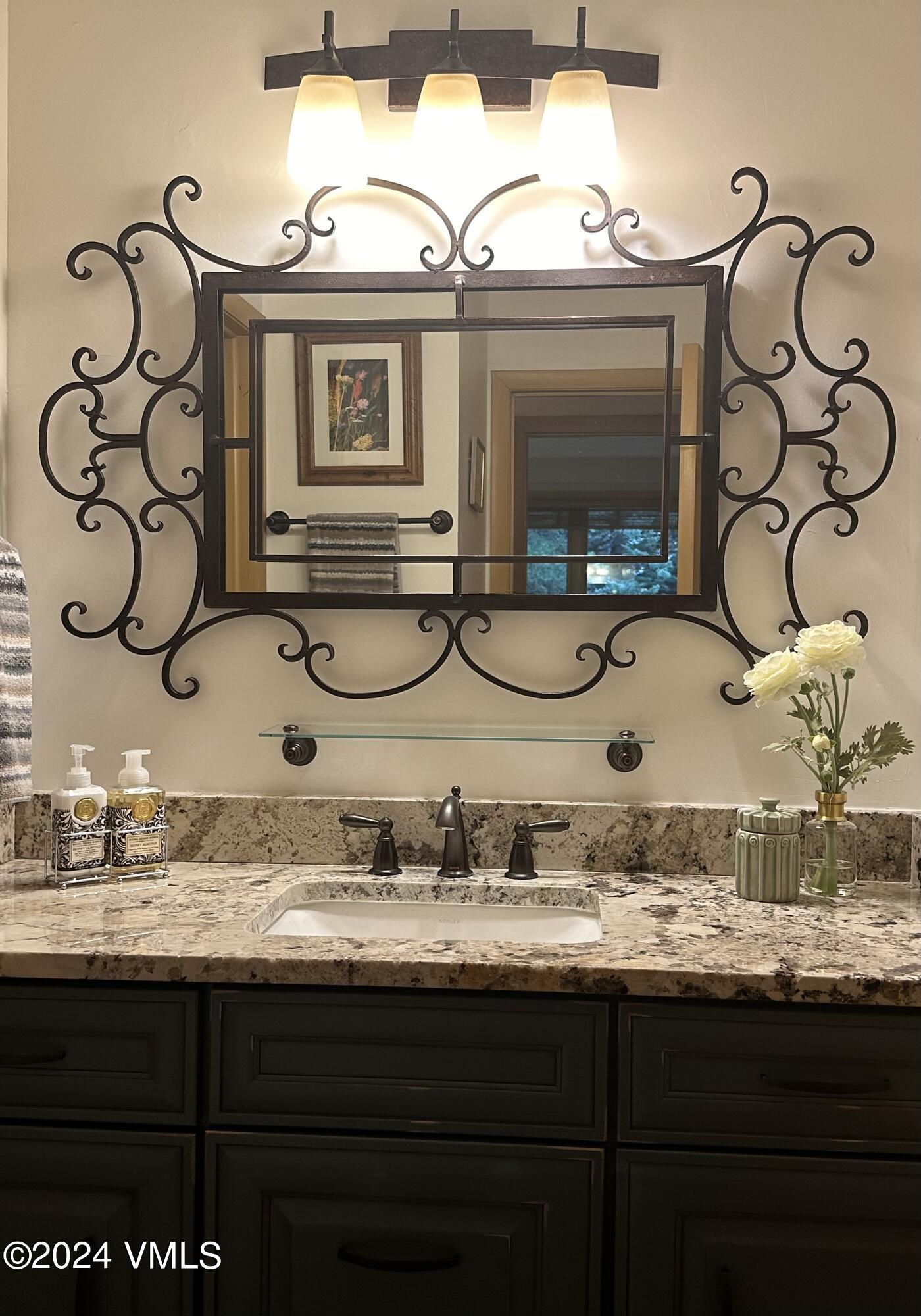 595 Vail Valley Drive, Unit E121 Vail, CO 81657 - Photo 9 of 12 a bathroom with a sink and a mirror