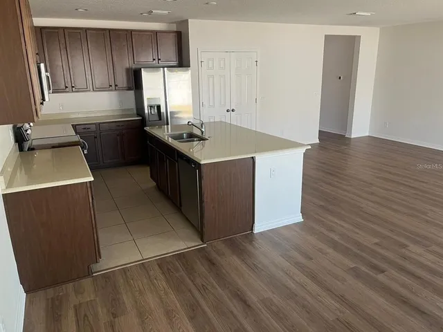 a kitchen with a cabinets and wooden floor