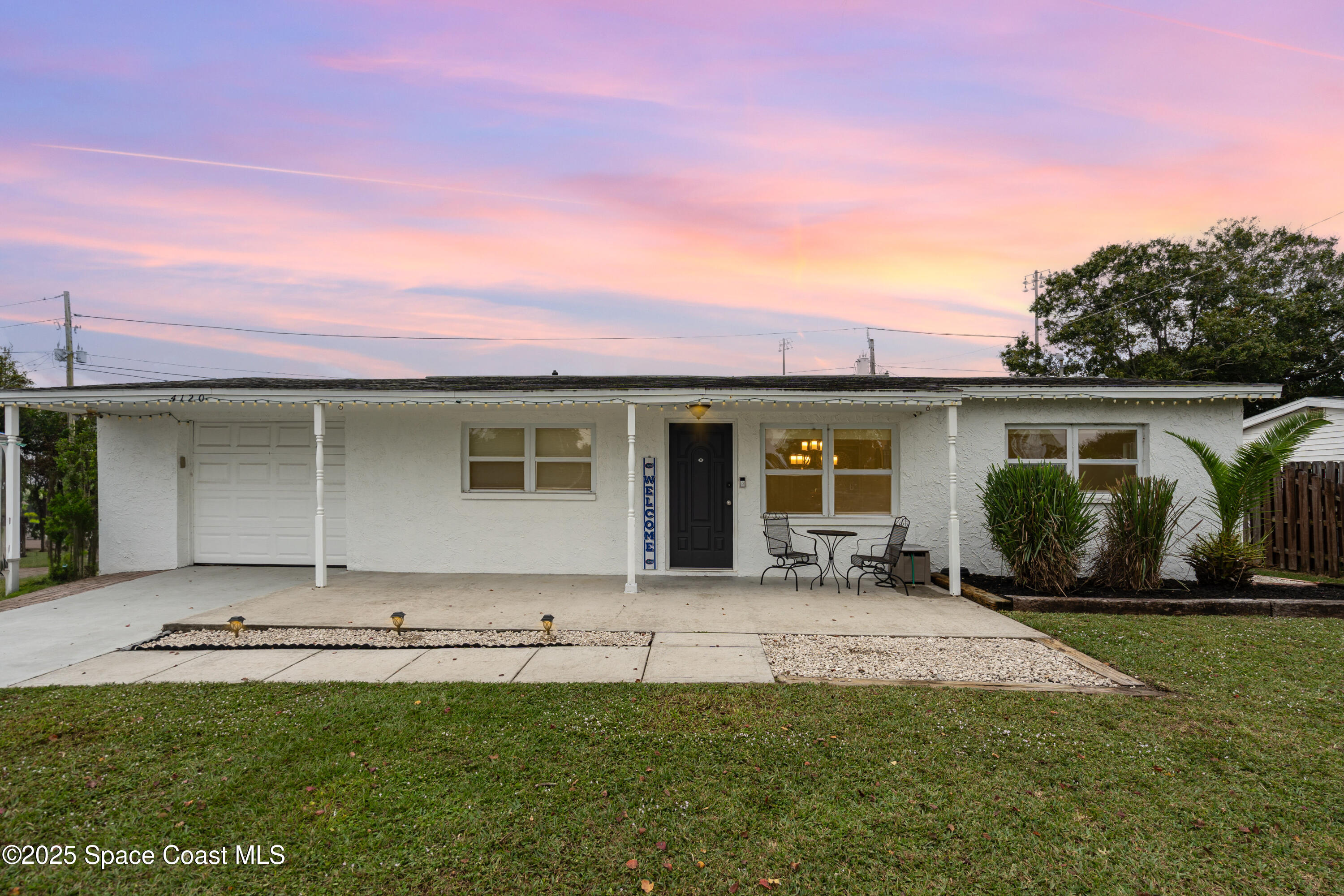 4120 Duke Street Melbourne, FL 32901 - Photo 1 of 29 a front view of a house with a garden