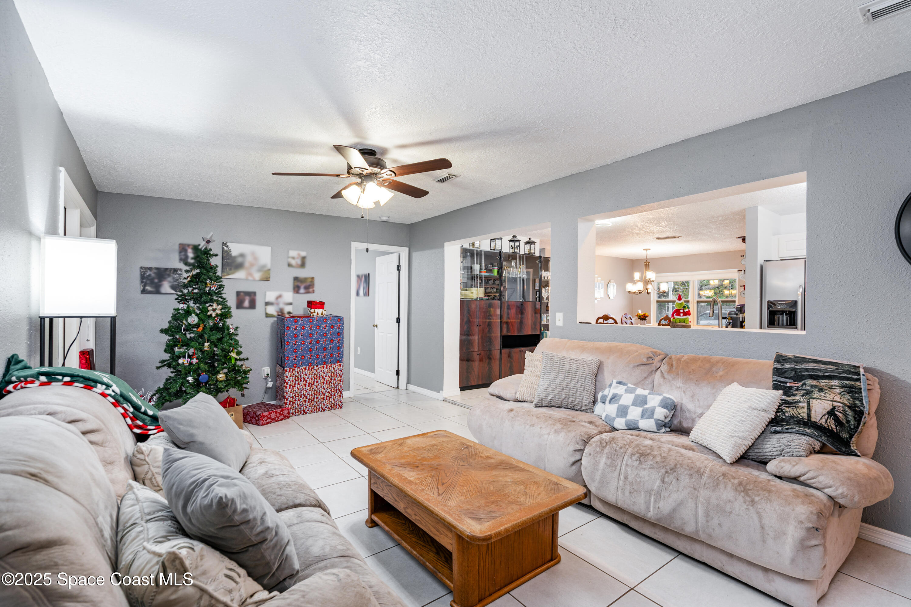 4120 Duke Street Melbourne, FL 32901 - Photo 11 of 29 a living room with furniture and a chandelier